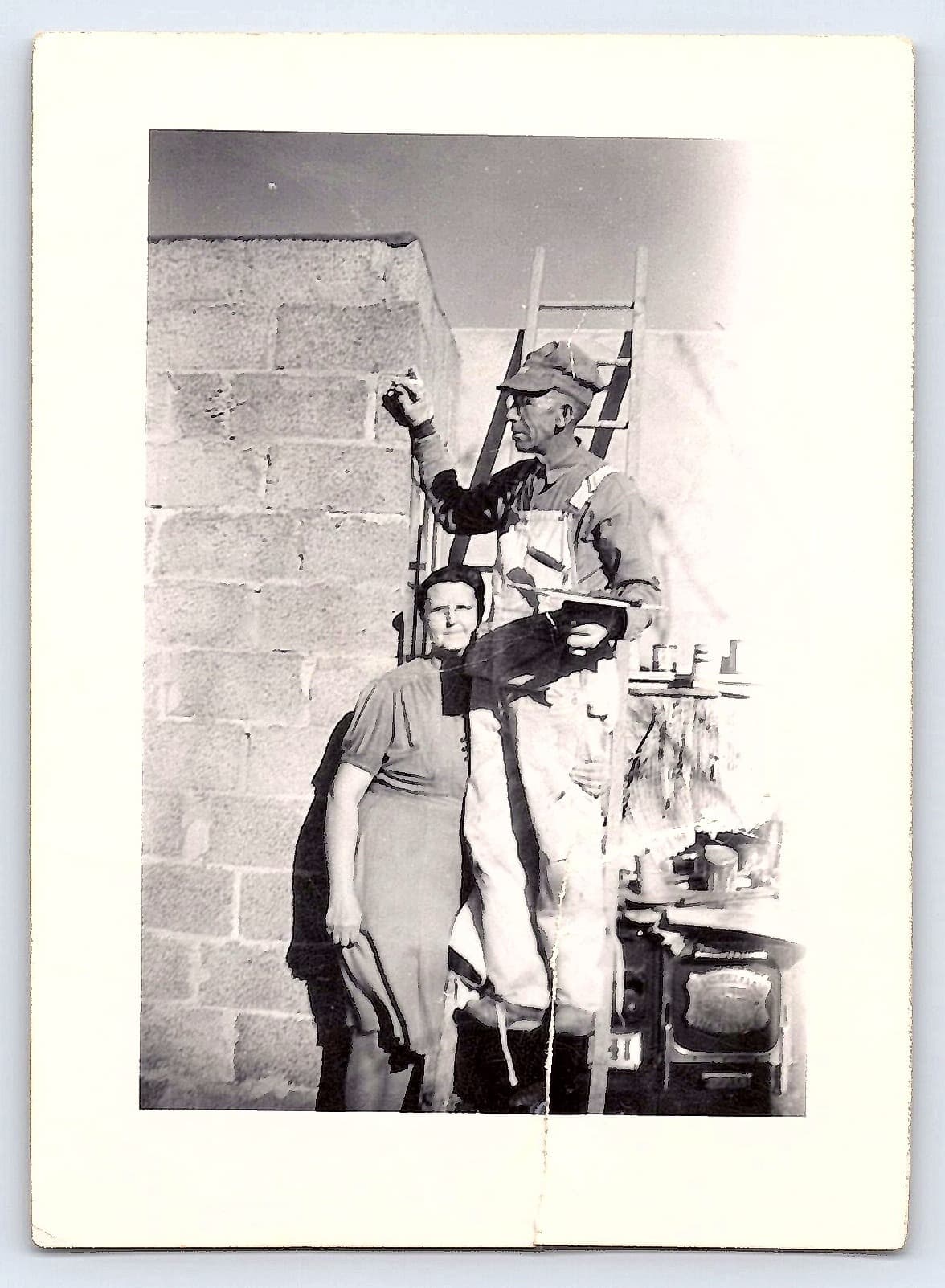 Couple by Brick Wall, Black and White Photograph, 2.7 × 3.77 inches, 1950s