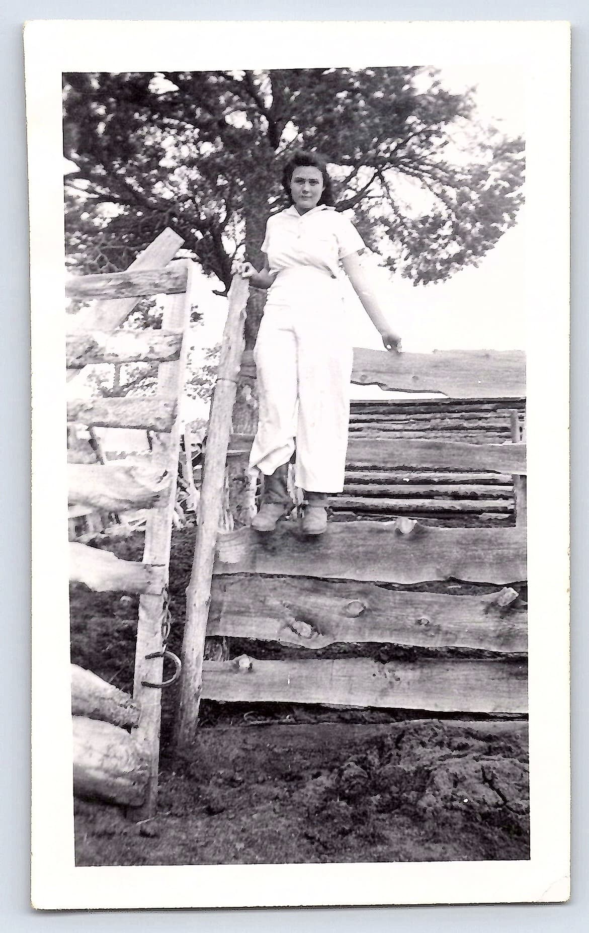 Woman on Fence, Black and White Photograph, 2.69 × 4.4 inches, 1940s